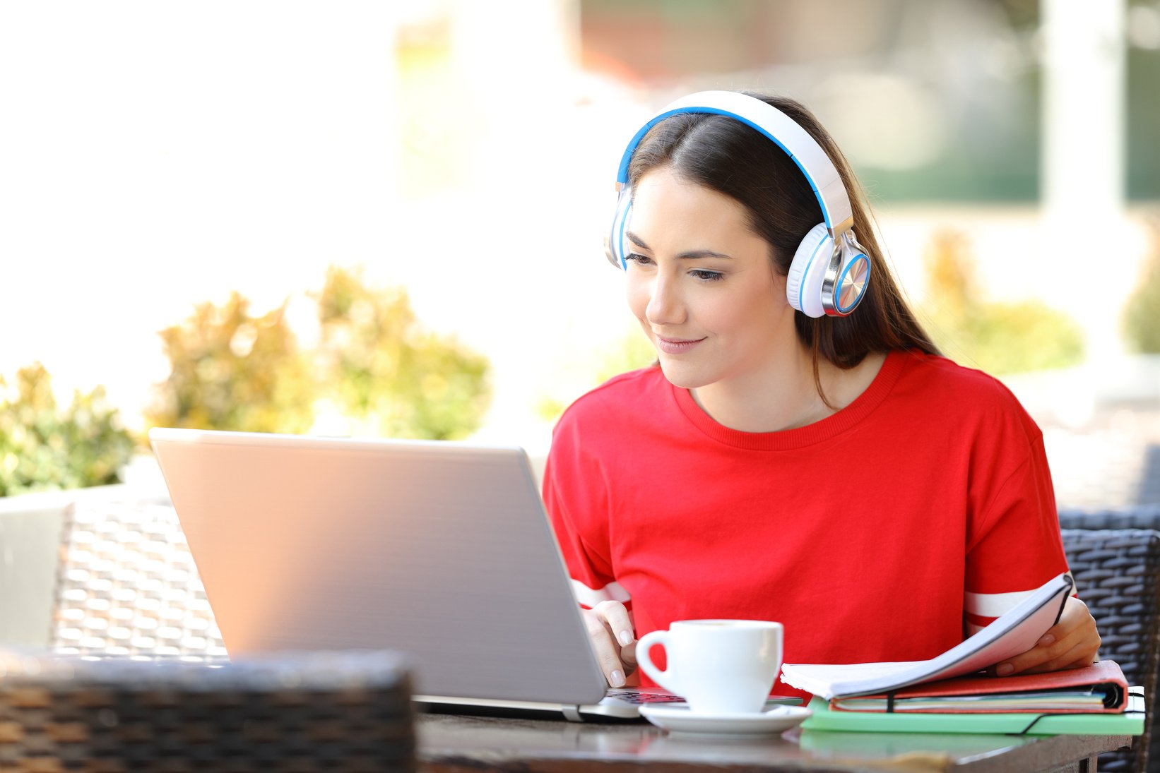 Student with headphones e-learning with a laptop